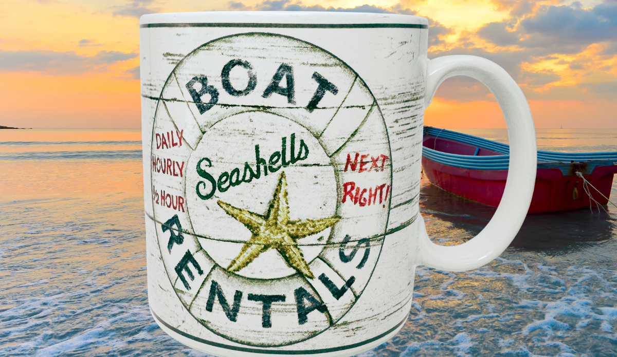 Casa Moda Boat Rentals Seashells Mug displayed beside ocean water, sunset sky, and small boat