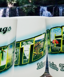 Three angles of Monteagle Mountain Tennessee Souvenir Mug displayed against a wooded waterfall background