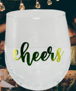 Cheers Stemless Wine Glass displayed at a lively celebration with friends