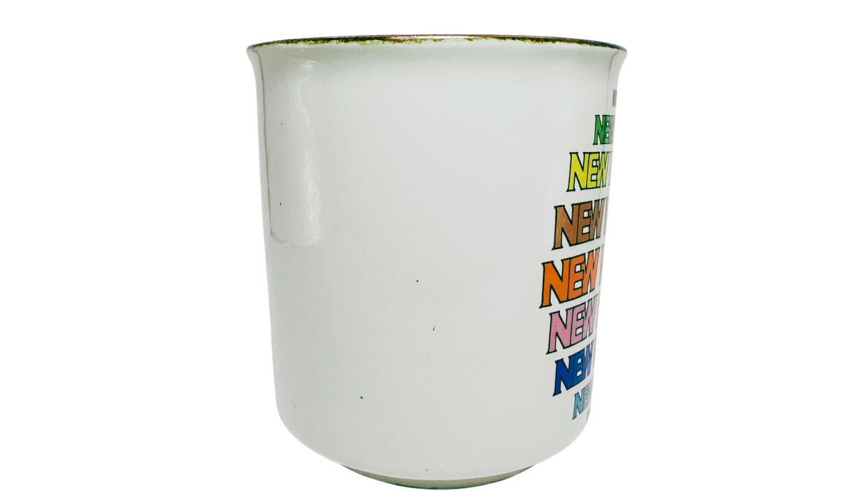 New Hampshire Rainbow Souvenir Mug middle view with white surface and colorful lettering visible along the edge
