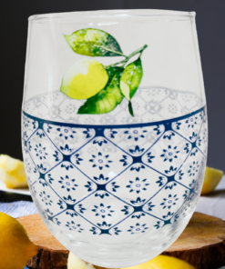 Lemon Stemless Wine Glass displayed with fresh lemons in a bright summer table setting