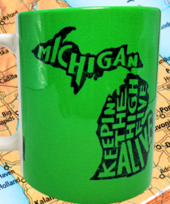 Keeping The High Five Alive Michigan Mug displayed against a detailed map of Michigan