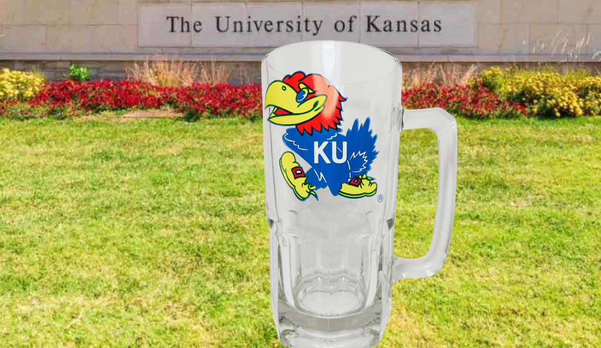 Kansas Jayhawks Glass Beer Mug displayed against a University of Kansas campus backdrop