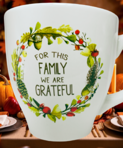 Family We Are Grateful Coffee Mug at Thanksgiving table with pumpkins, autumn place settings, and warm fall decorations
