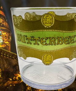Harry Potter Clear Butterbeer Souvenir Cup in a dramatic wizarding-themed nighttime setting
