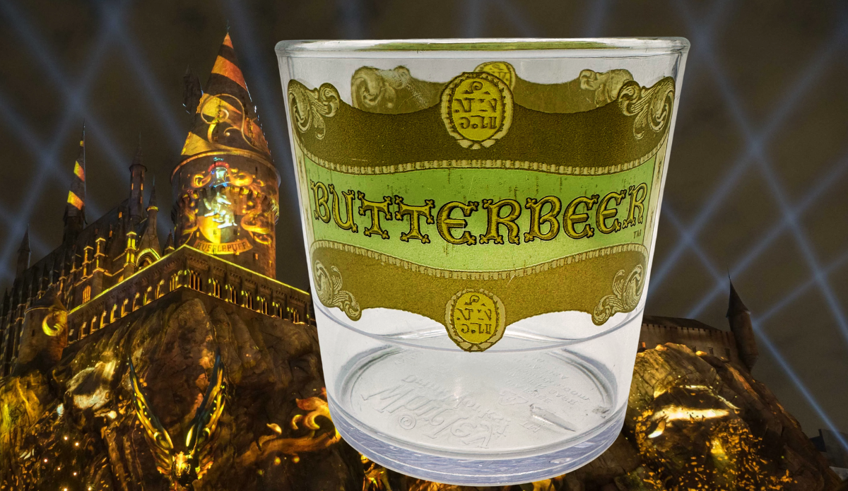 Harry Potter Clear Butterbeer Souvenir Cup in a dramatic wizarding-themed nighttime setting