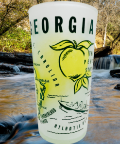 Vintage Georgia Peach Map Glass displayed beside a scenic wooded stream with flowing water and autumn scenery