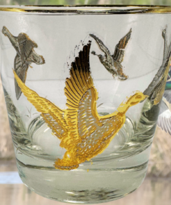 Vintage Game Bird Whiskey Glass displayed in a marsh scene with flying ducks
