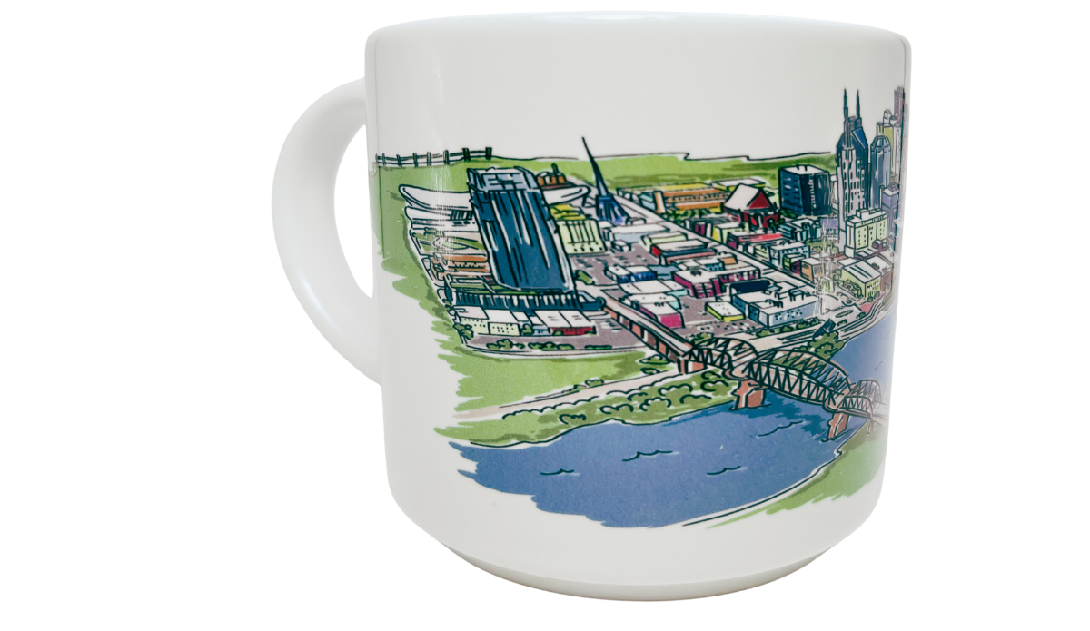 Nashville Tennessee Souvenir Mug side view with bridge, river, skyline buildings, and green city landscape