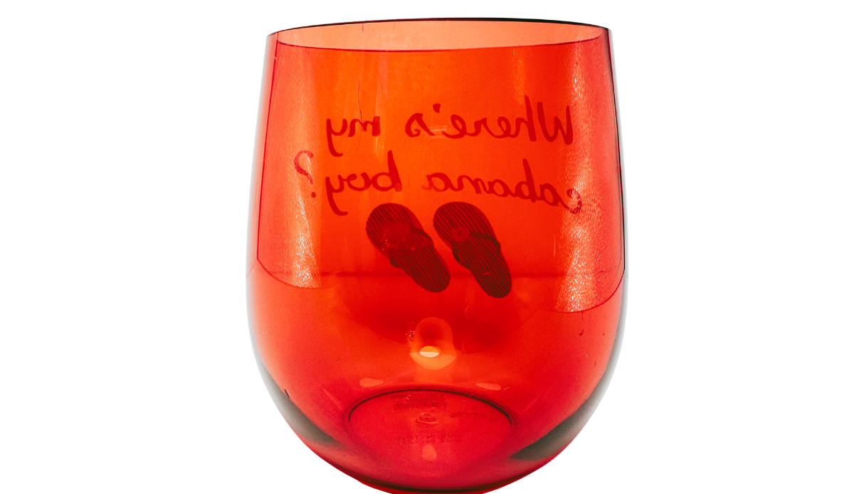 Cabana Boy Acrylic Wine Glass back view with cabana wording and flip-flops visible through red acrylic
