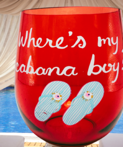 Cabana Boy Acrylic Wine Glass displayed in a tropical poolside cabana setting