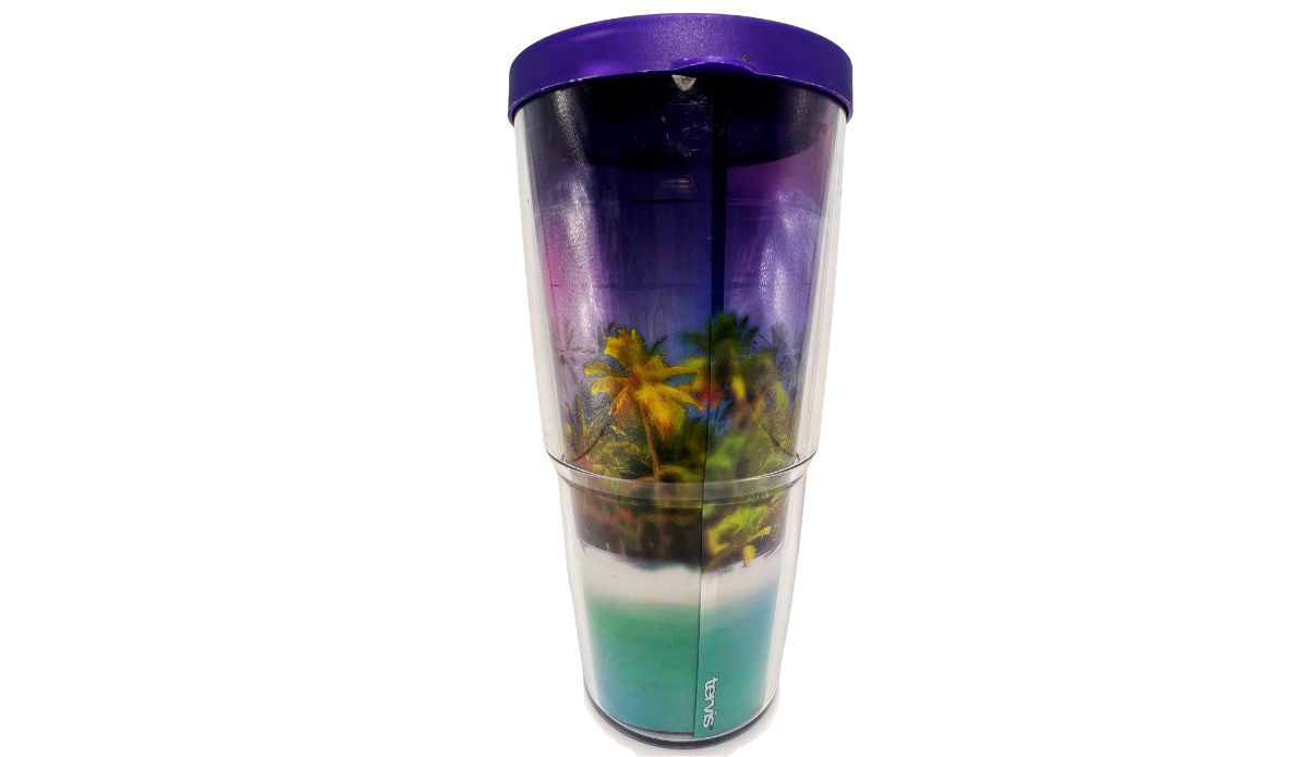 Back view of Tervis Palm Trees Cool Breeze Tumbler With Lid showing tropical foliage, purple sunset tones, turquoise water, and vertical Tervis logo.