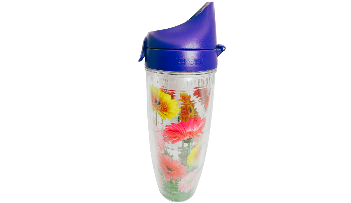Right side view of Tervis Gerbera Daisies Water Bottle showing purple flip-top lid, molded Tervis logo, and colorful yellow, pink, and coral flowers.