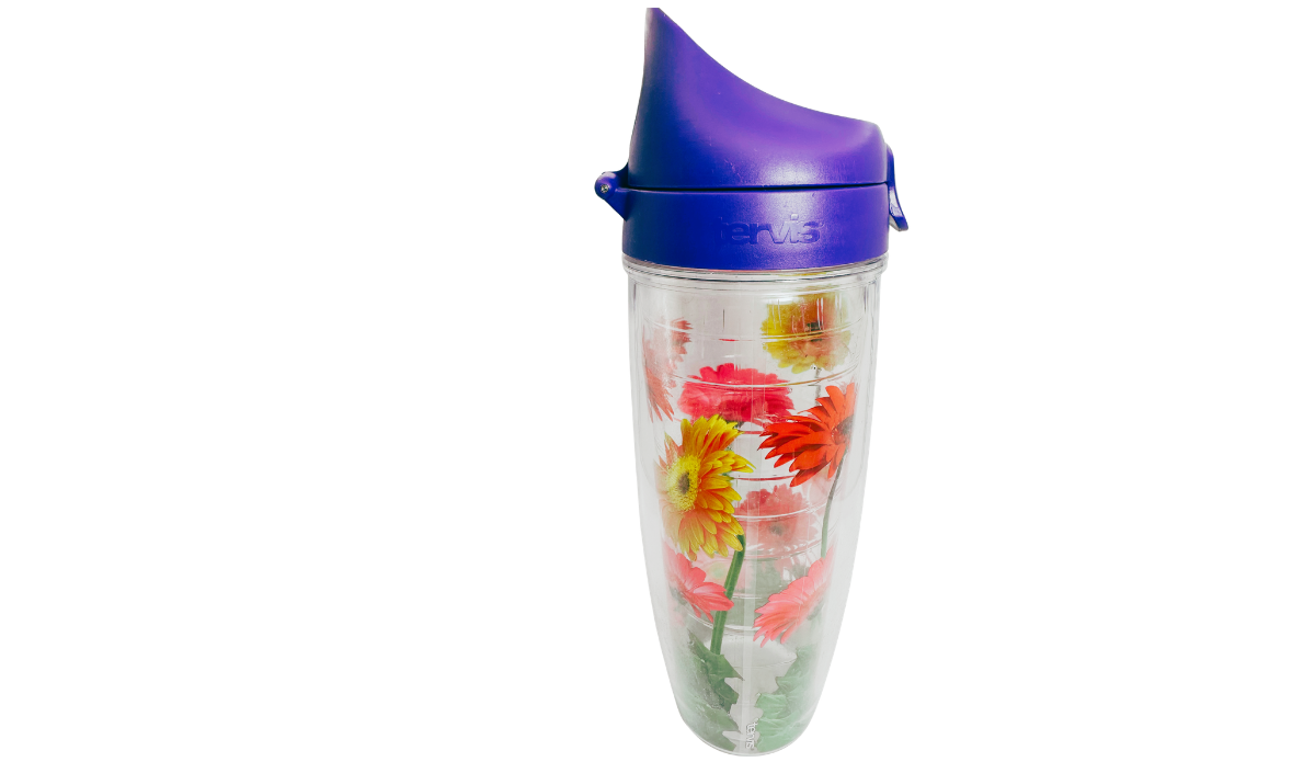 Left side view of Tervis Gerbera Daisies Water Bottle featuring purple flip-top carrying lid, red and yellow gerbera daisies, and clear insulated construction.