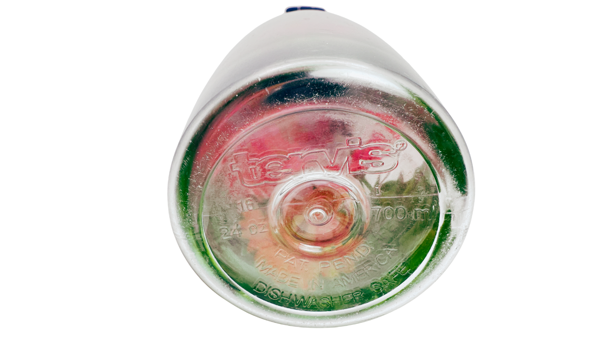 Bottom view of Tervis Gerbera Daisies Water Bottle showing embossed Tervis branding, 24 oz and 700 mL capacity, Made in America, and dishwasher-safe markings.