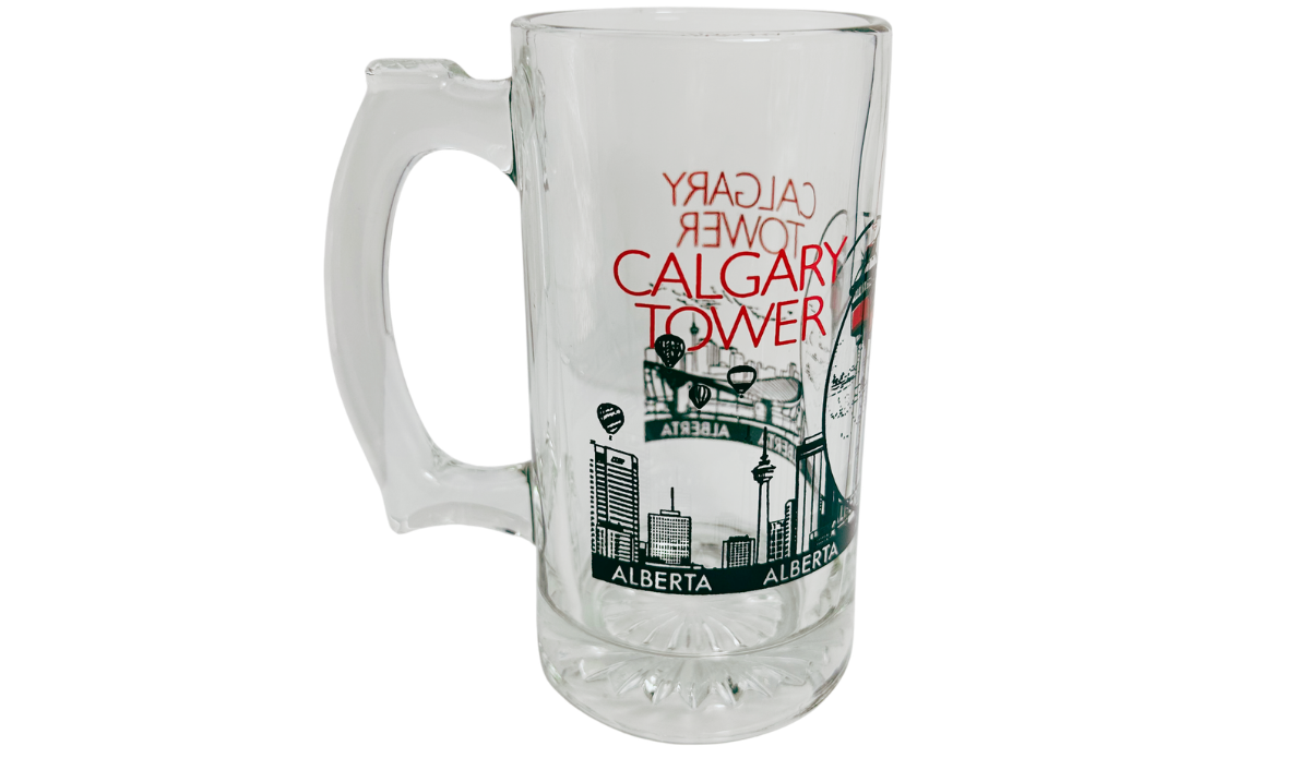 Calgary Tower Beer Mug front view with red Calgary Tower lettering, Alberta skyline artwork, and clear glass handle