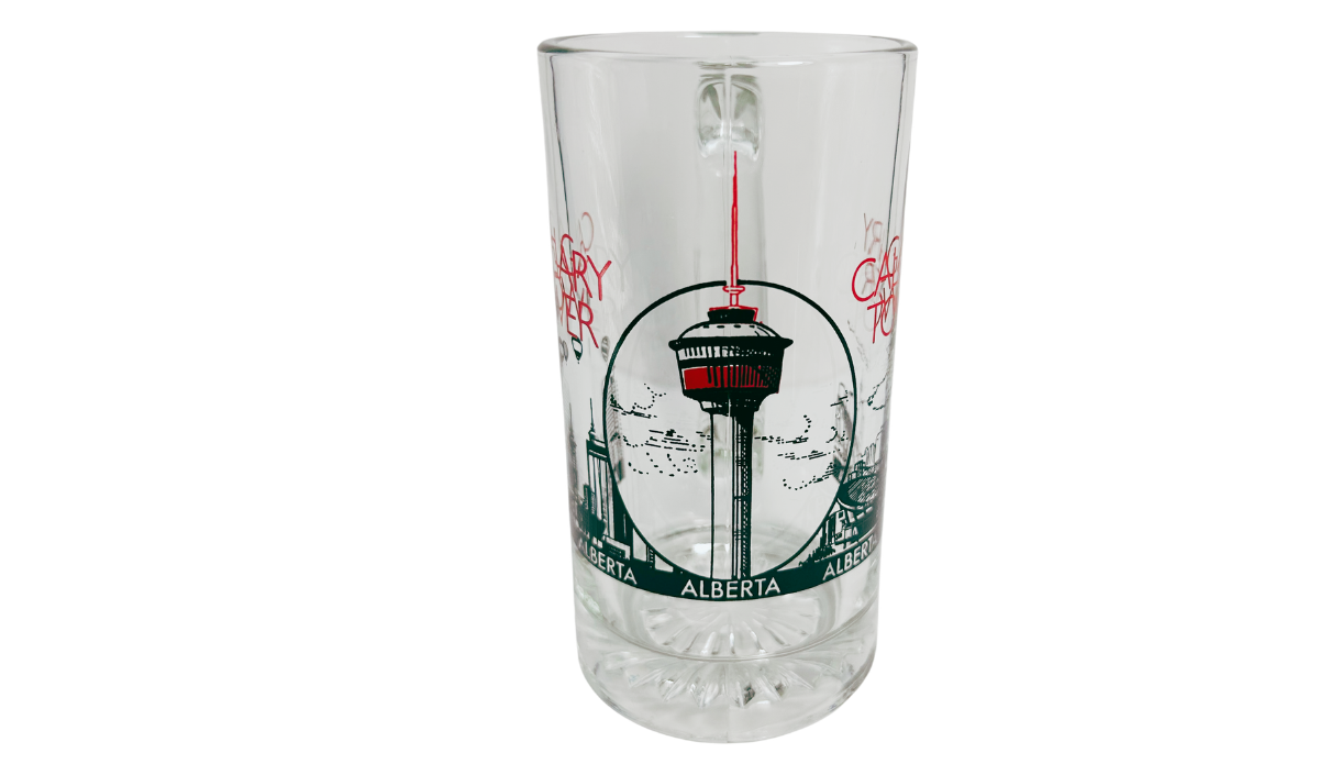 Calgary Tower Beer Mug middle view with illustrated Calgary Tower, red accents, Alberta lettering, and clear glass body