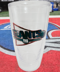 Tervis New York Giants Pennant Tumbler displayed in a football lifestyle scene with Giants helmet artwork at MetLife Stadium.
