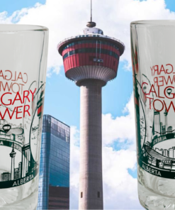 Calgary Tower Beer Mug lifestyle scene showing two glass mug views against Calgary Tower and downtown skyline
