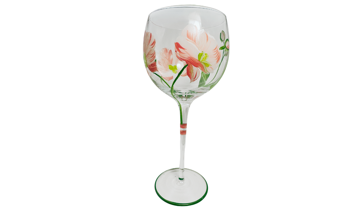 Side view of Hand Painted White Pink Flower Balloon Wine Glass showing creamy white and coral-edged blossoms, small flowers, curved green stems and painted foot.