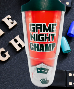 Tervis Game Night Champ Tumbler With Lid displayed in a game-night setting with dominoes, colorful playing pieces, and wooden GAME NIGHT letters.
