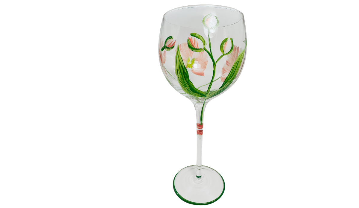 Hand Painted White Pink Flower Balloon Wine Glass with unopened flower buds, curved green stems, pointed leaves and pale coral blossoms.
