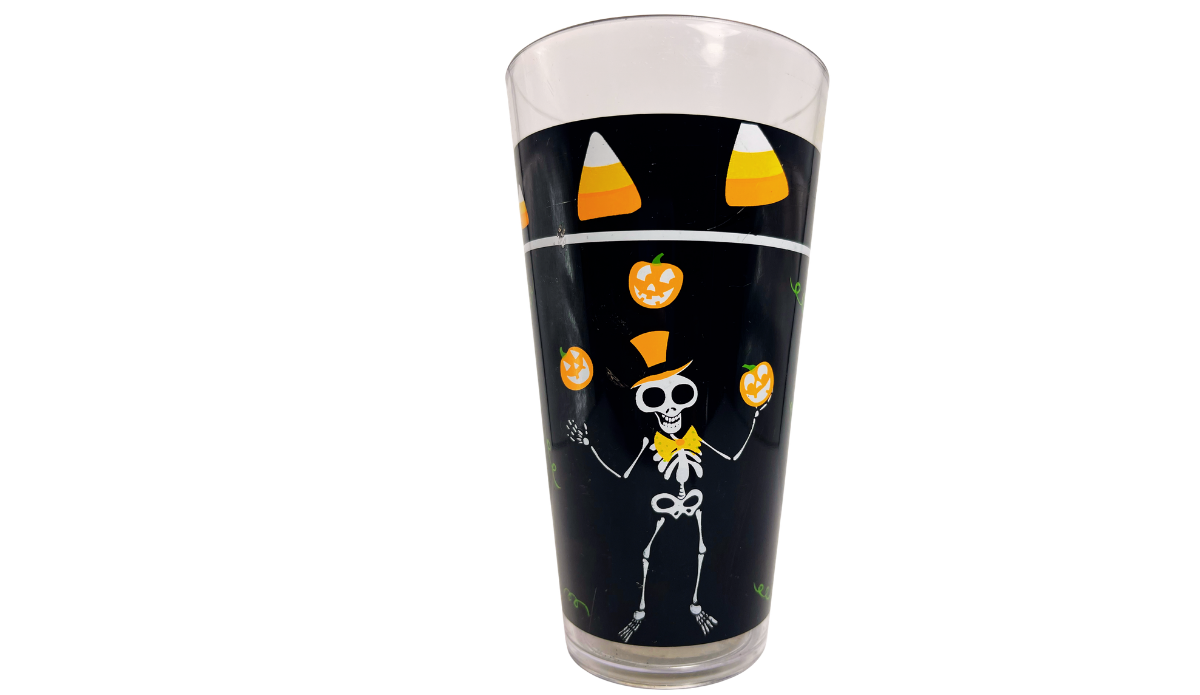 Back view of Juggling Skeleton Halloween Acrylic Tumbler featuring skeleton juggling pumpkins beneath candy corn artwork