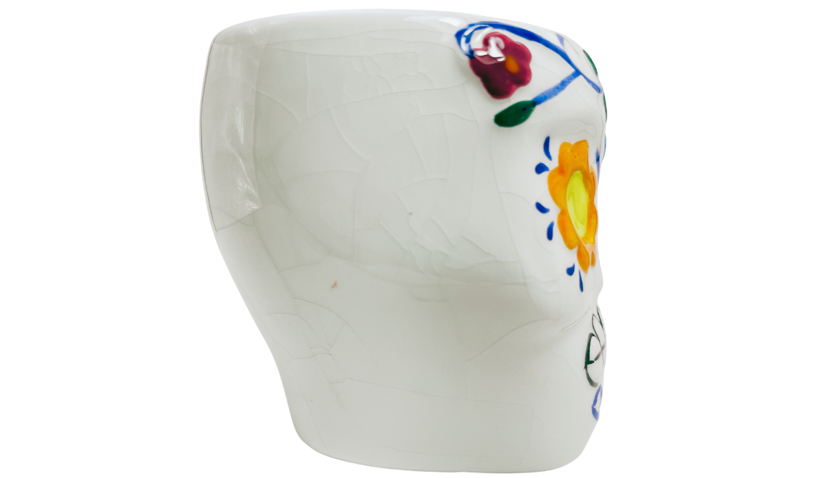 Left side view of Floral Sugar Skull Mug showing white sculpted body with partial orange flower eye and colorful accents