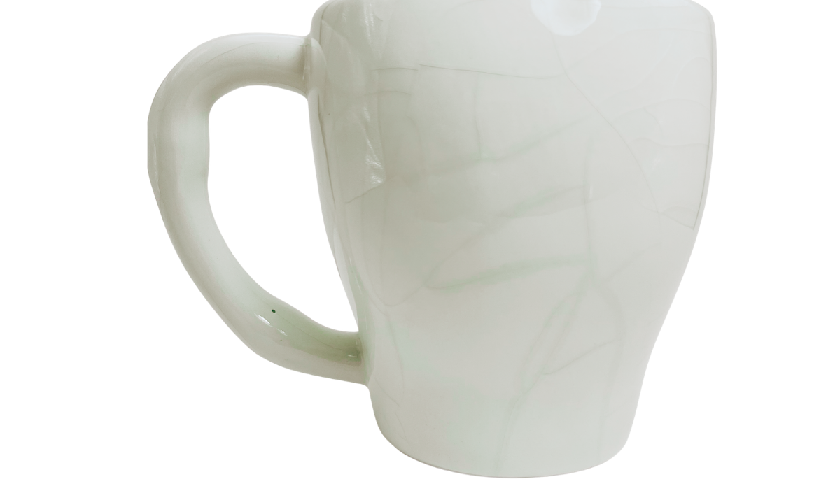 Back view of Floral Sugar Skull Mug showing white sculpted skull body and curved mug handle