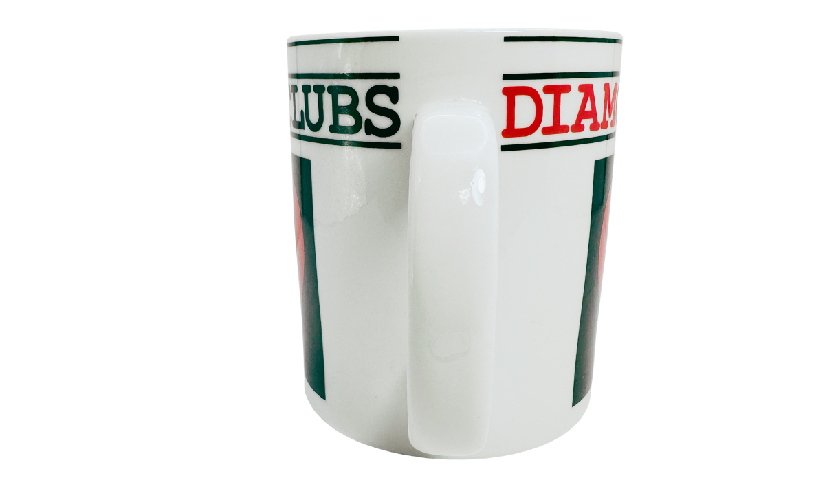 Hearts Playing Cards Coffee Mug handle view showing the white ceramic handle between sections of the Hearts, Clubs, and Diamonds lettering.
