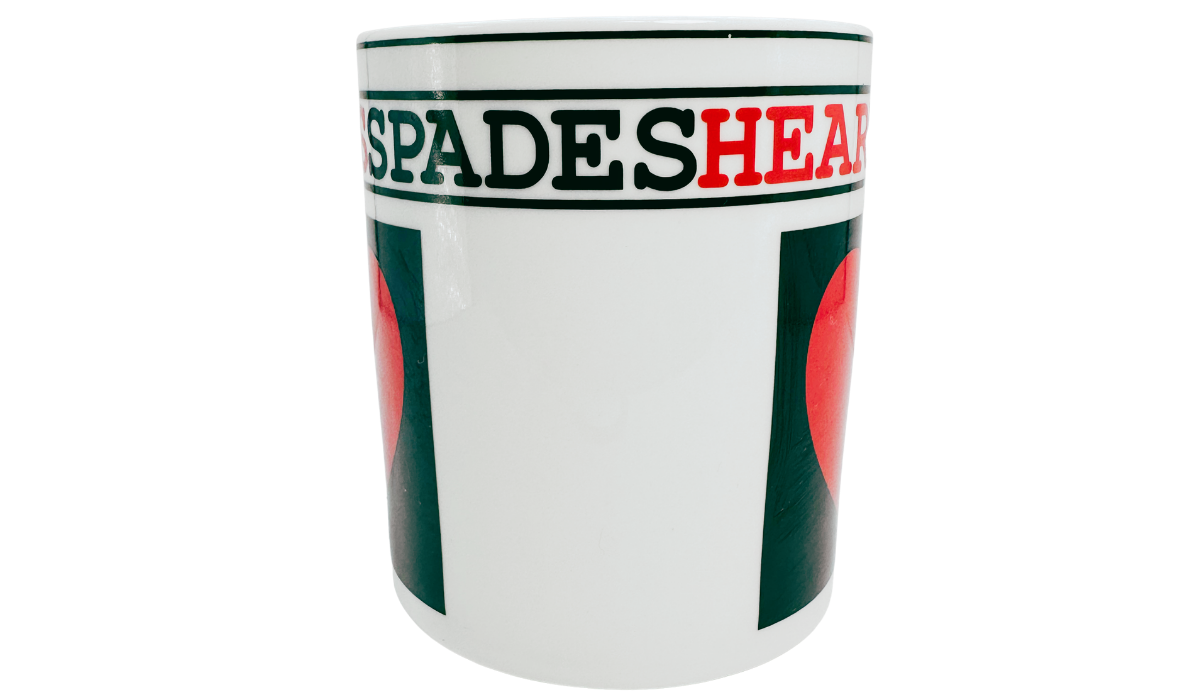 Hearts Playing Cards Coffee Mug middle view showing Spades and Hearts lettering above a white section between the two dark green heart panels.