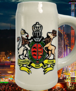 Cannstatter Volksfest Beer Stein displayed against colorful illuminated Volksfest rides