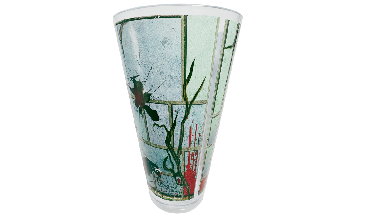 Left rear view of HHN 2025 Souvenir Cup with cracked glass artwork, dark bird, vines, and red details