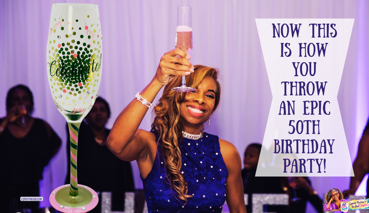Khadeeja smiling and raising a champagne flute during her 50th birthday celebration, beside a colorful Celebrate champagne glass.