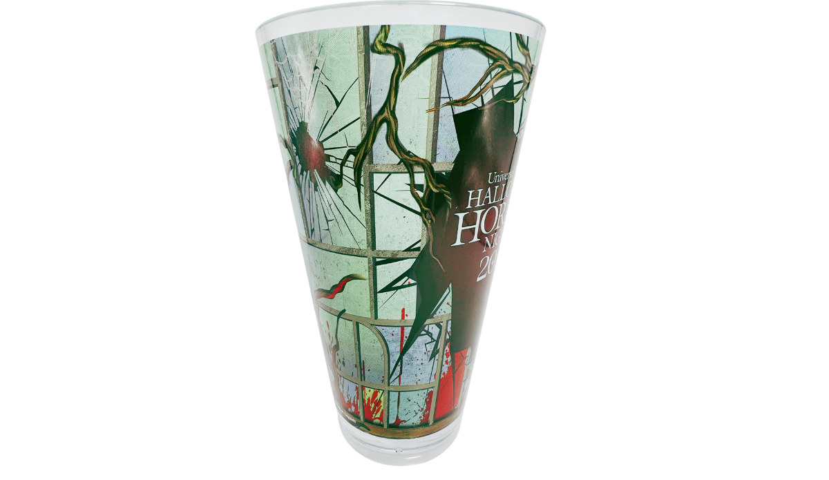 Left side view of HHN 2025 Souvenir Cup with partial Halloween Horror Nights branding and shattered window design