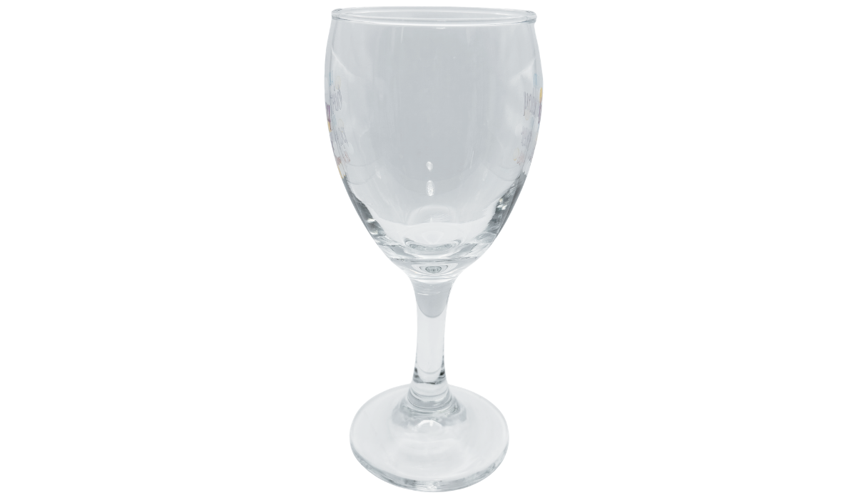 Left side view of Happy Birthday Partner In Wine Glass showing its transparent bowl, partial birthday lettering, clear stem, and circular foot.