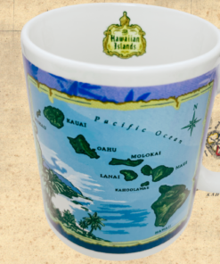 Hawaiian Islands Blue Map Coffee Mug displayed against an antique Hawaii map with turquoise island artwork, white handle, and interior crest.