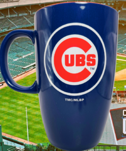 Chicago Cubs Navy Blue Latte Mug displayed against a Wrigley Field baseball scene with stadium seating, Cubs signage, and baseball diamond.