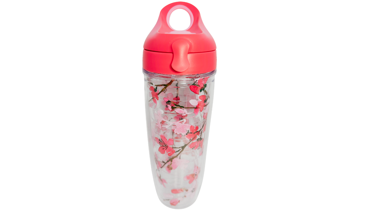 Tervis Japanese Cherry Blossom Water Bottle front view with pink sakura flowers, brown branches, clear insulated body and coral-pink flip-top loop lid.