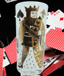King of Spades Playing Card Highball Glass displayed among scattered red-backed playing cards, with black spades and red hearts visible.